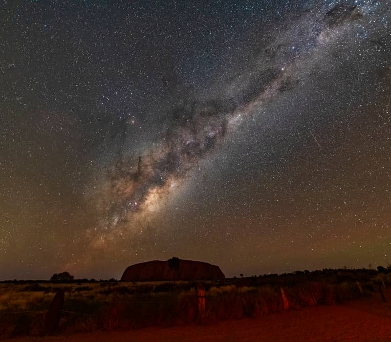 Milky Way over Uluru at night, with a starry sky in the background.